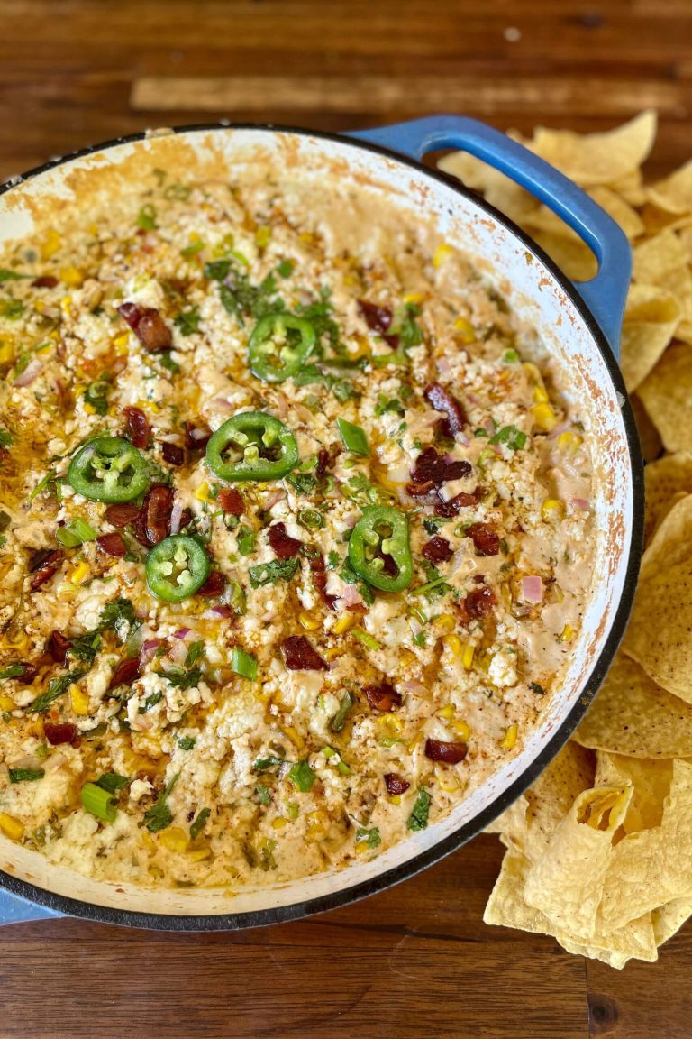 smoked street corn dip in a cast iron skillet with tortilla chips