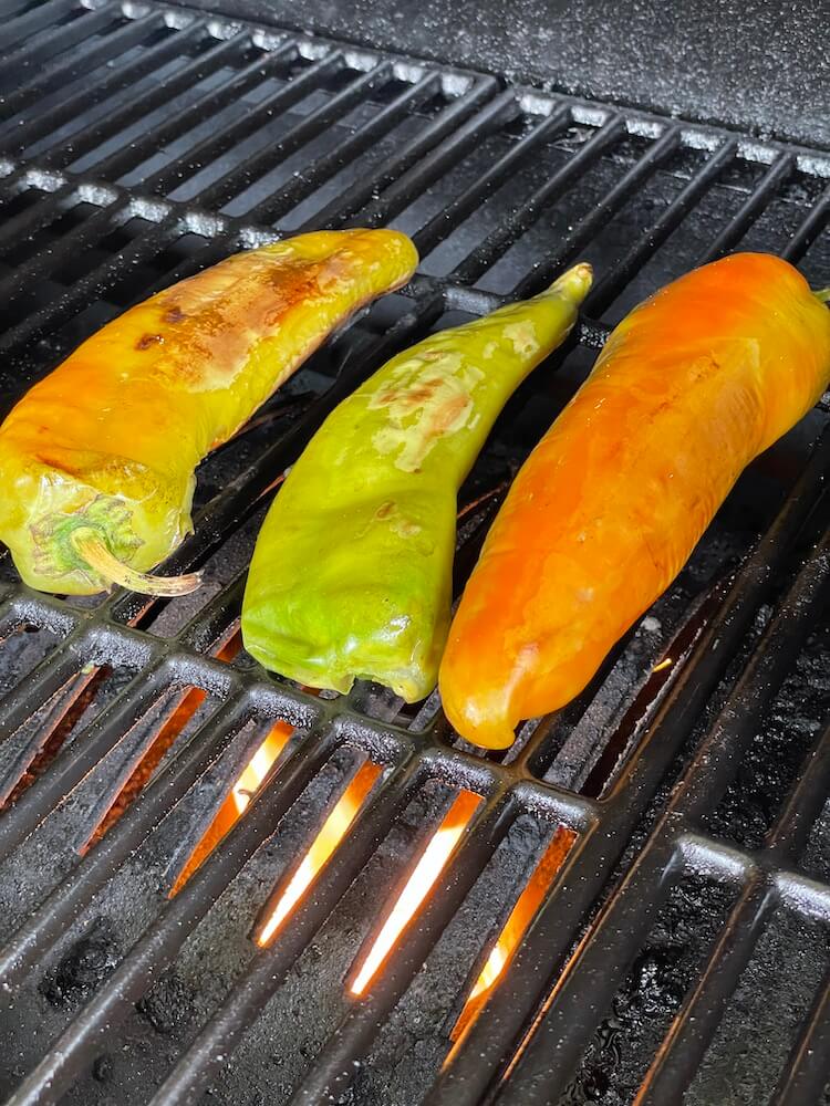 peppers roasting on a pit boss pellet grill with the sear plate open