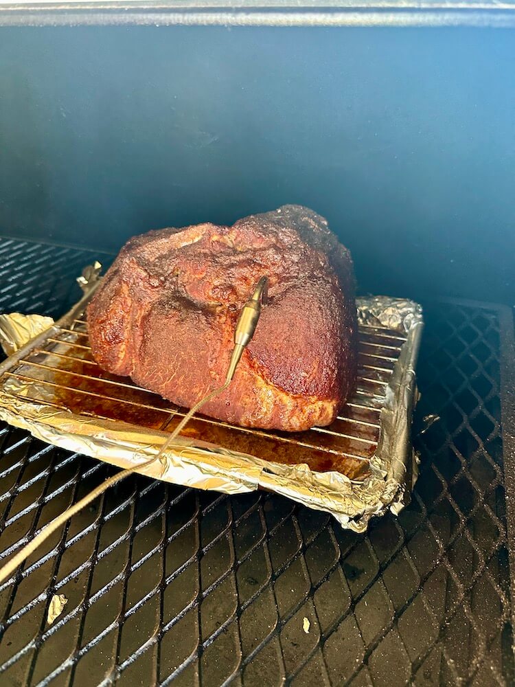 smoking a ham on a pellet grill with a wire rack and sheet tray underneath