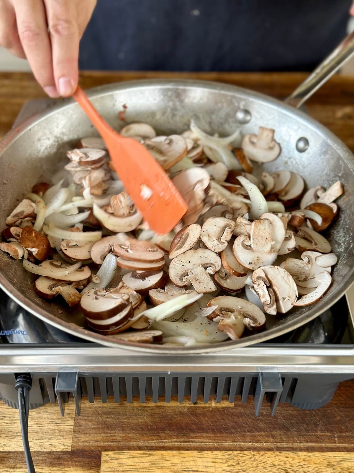 sautéing mushrooms and onions in a skillet