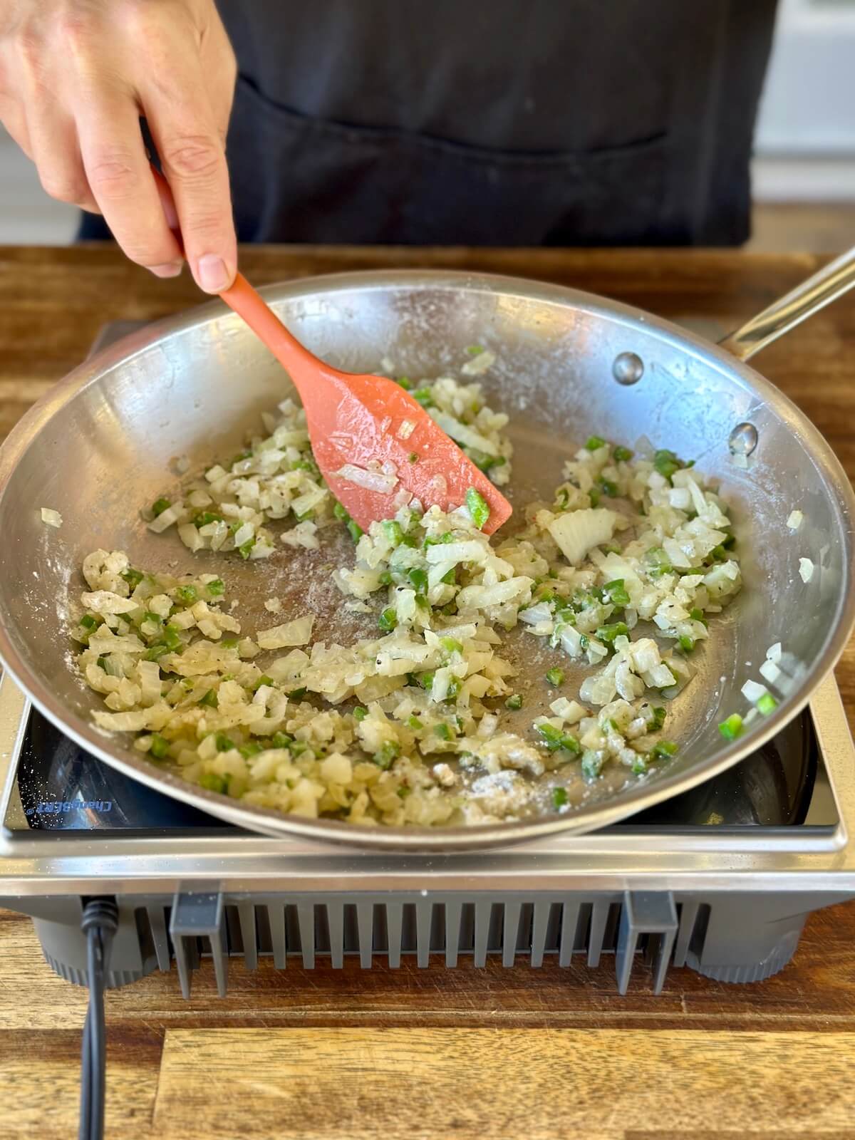 sautéing diced onions and jalapeños in a skillet
