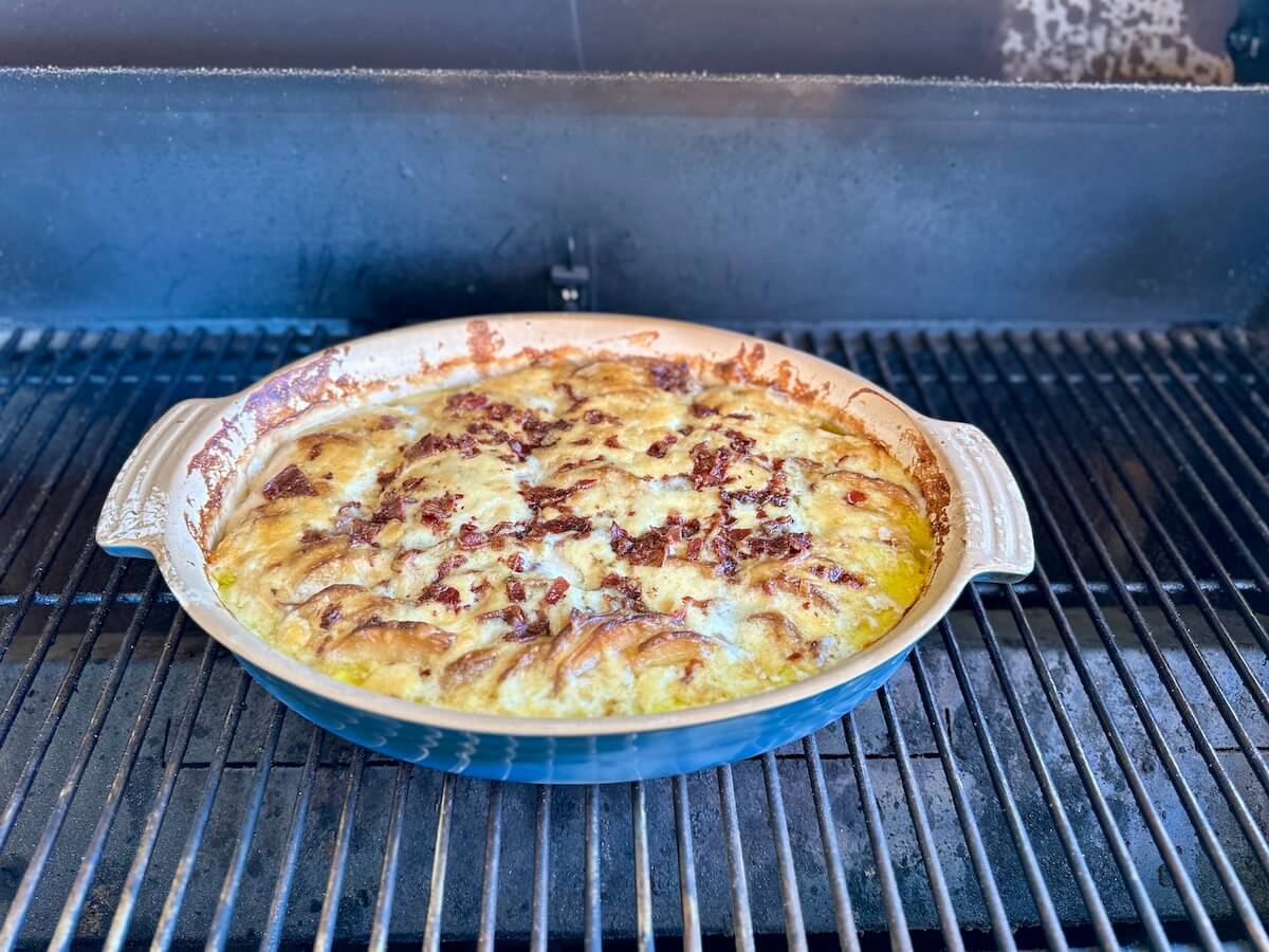 smoked scalloped potatoes cooking on a pellet grill