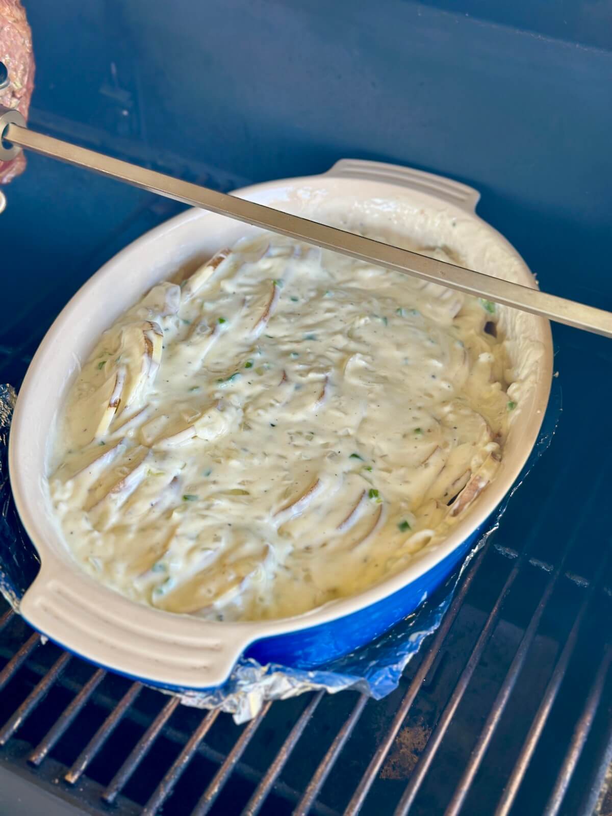 scalloped potatoes smoking on a pellet grill