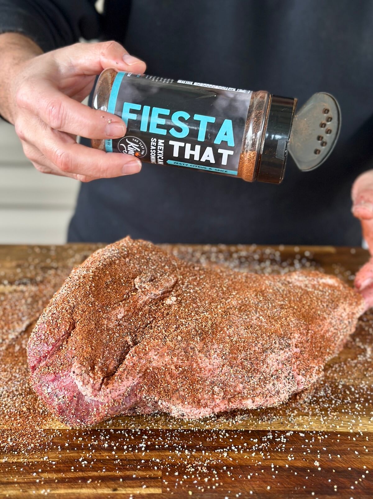 seasoning a brisket point with Mexican seasoning