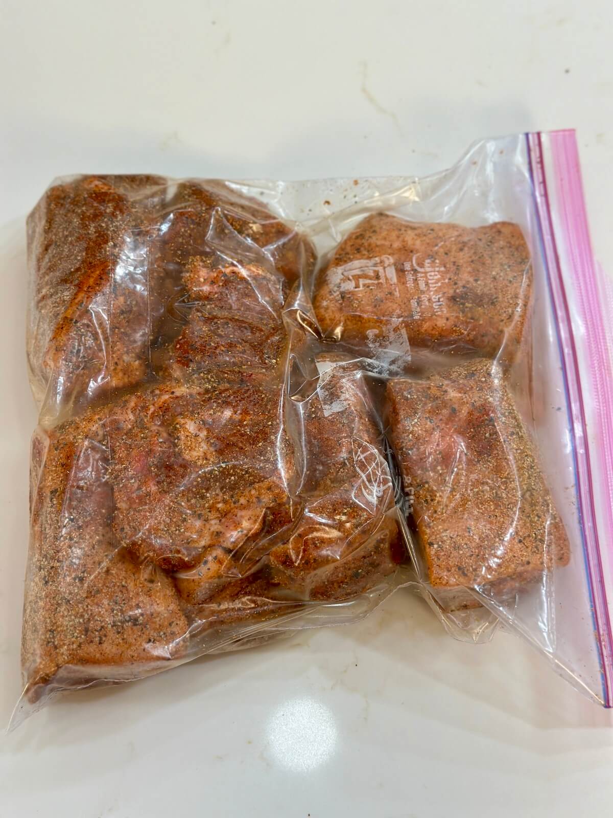 curing chunks of pork butt in a zip top bag