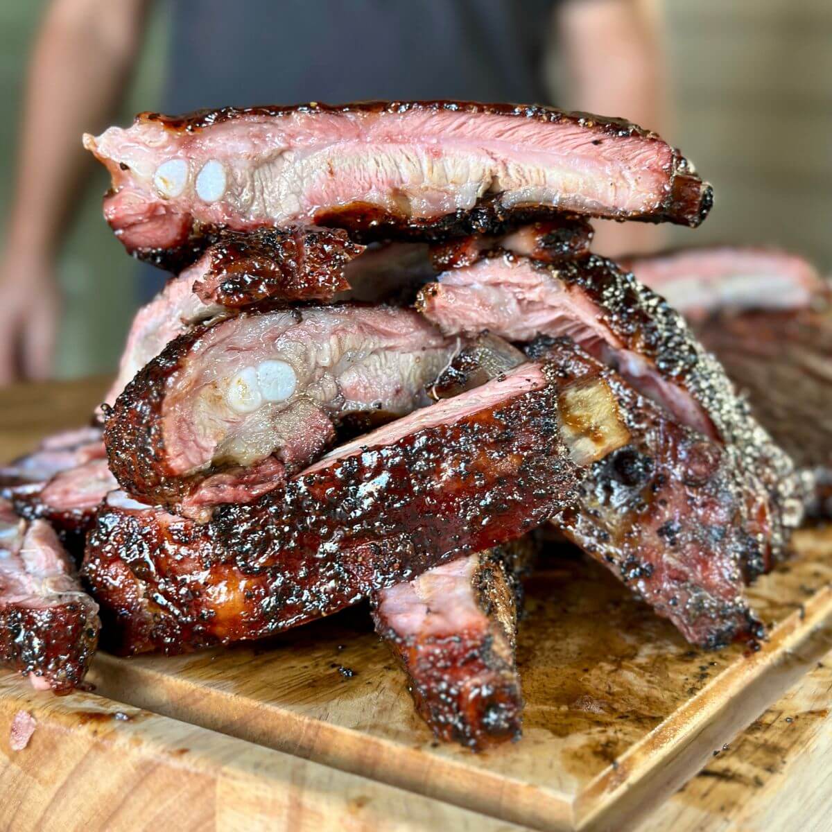 smoked pork spare ribs stacked up with barbecue sauce