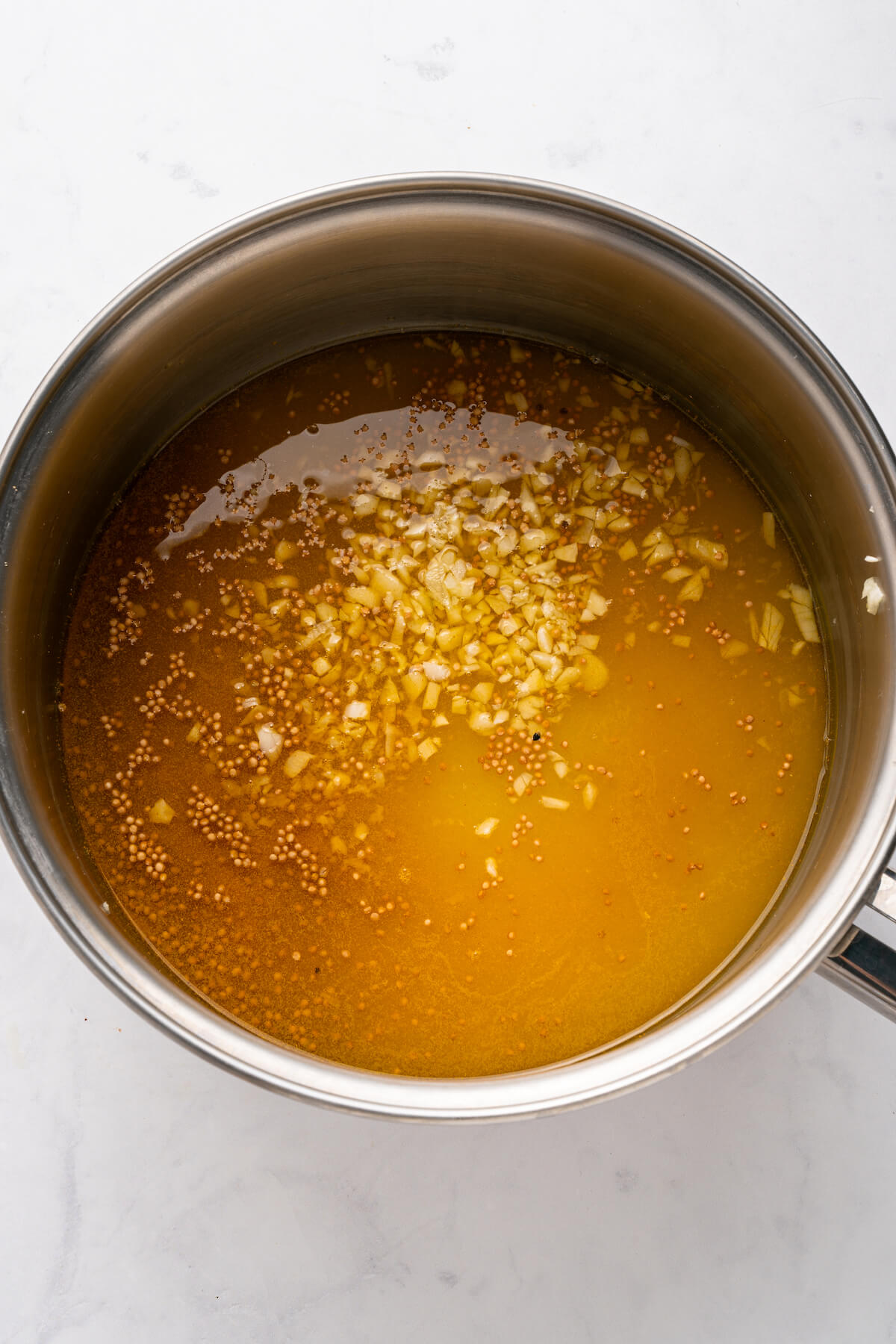 cooking a syrup mixture of sugar, apple cider vinegar, and spices in a saucepan