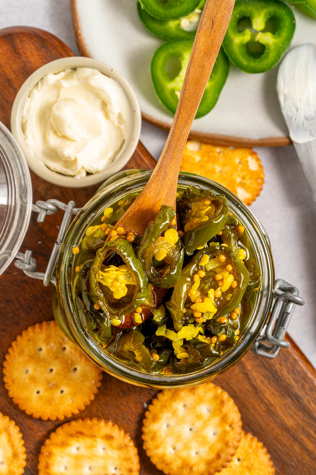 candied jalapenos in a jar with crackers