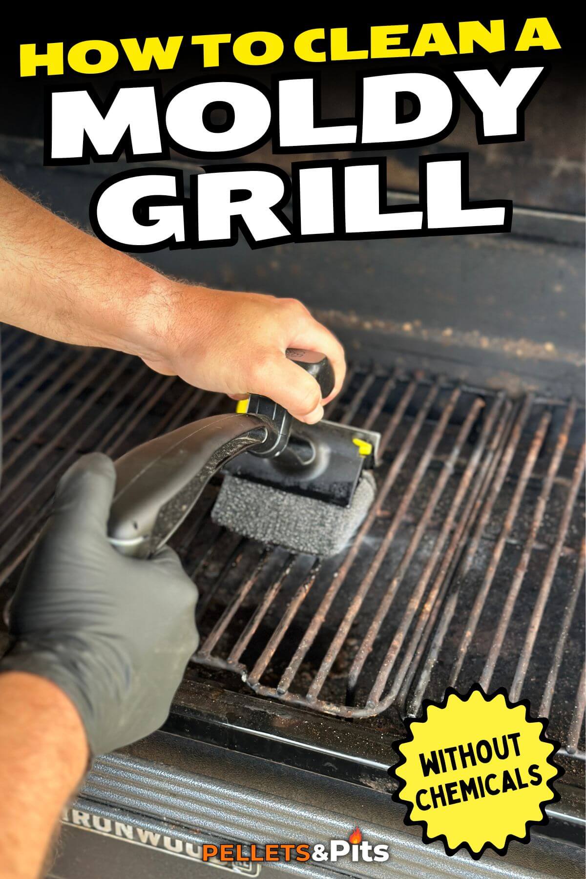 using a grill brush to clean the grill grates on a moldy grill