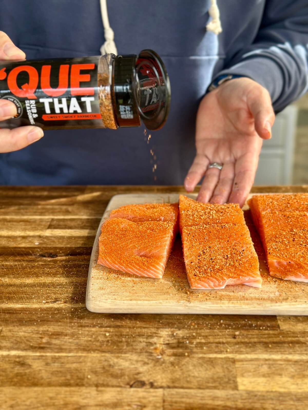 seasoning salmon filets with 'Que That barbecue seasoning