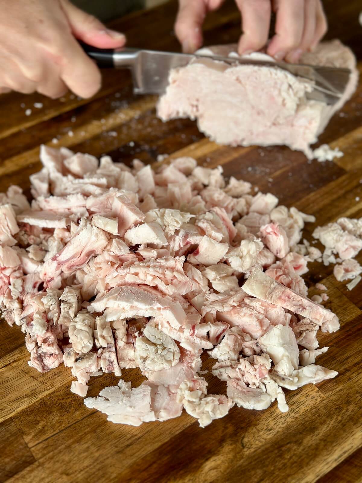 cutting brisket fat into small cubes