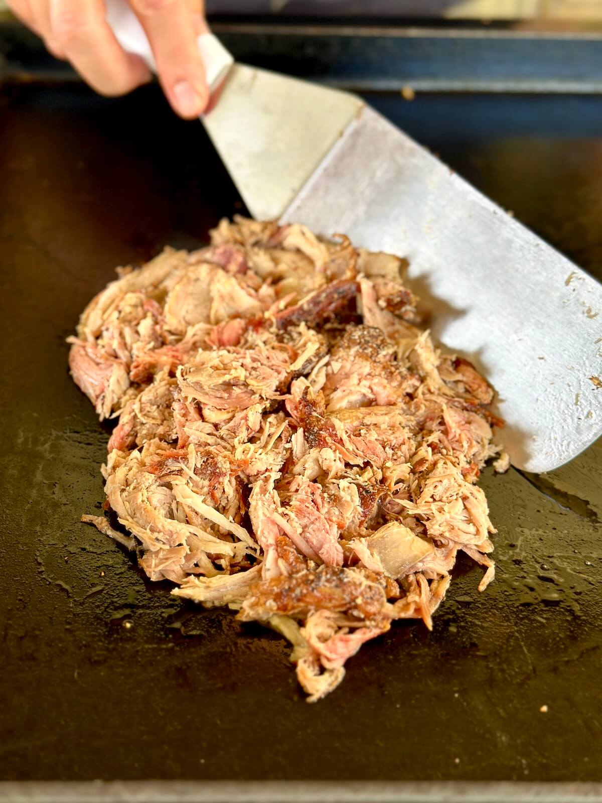 sautéing leftover pulled pork on a griddle
