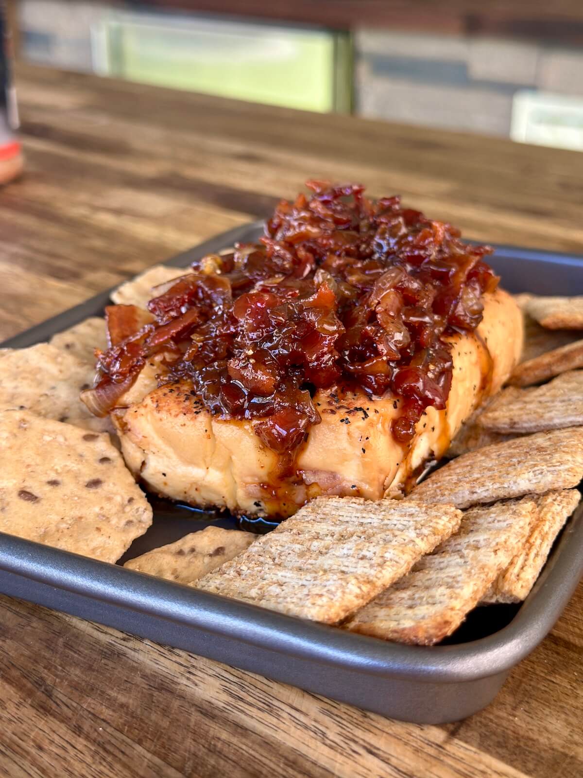 smoked cream cheese topped with bacon onion jam and served with crackers