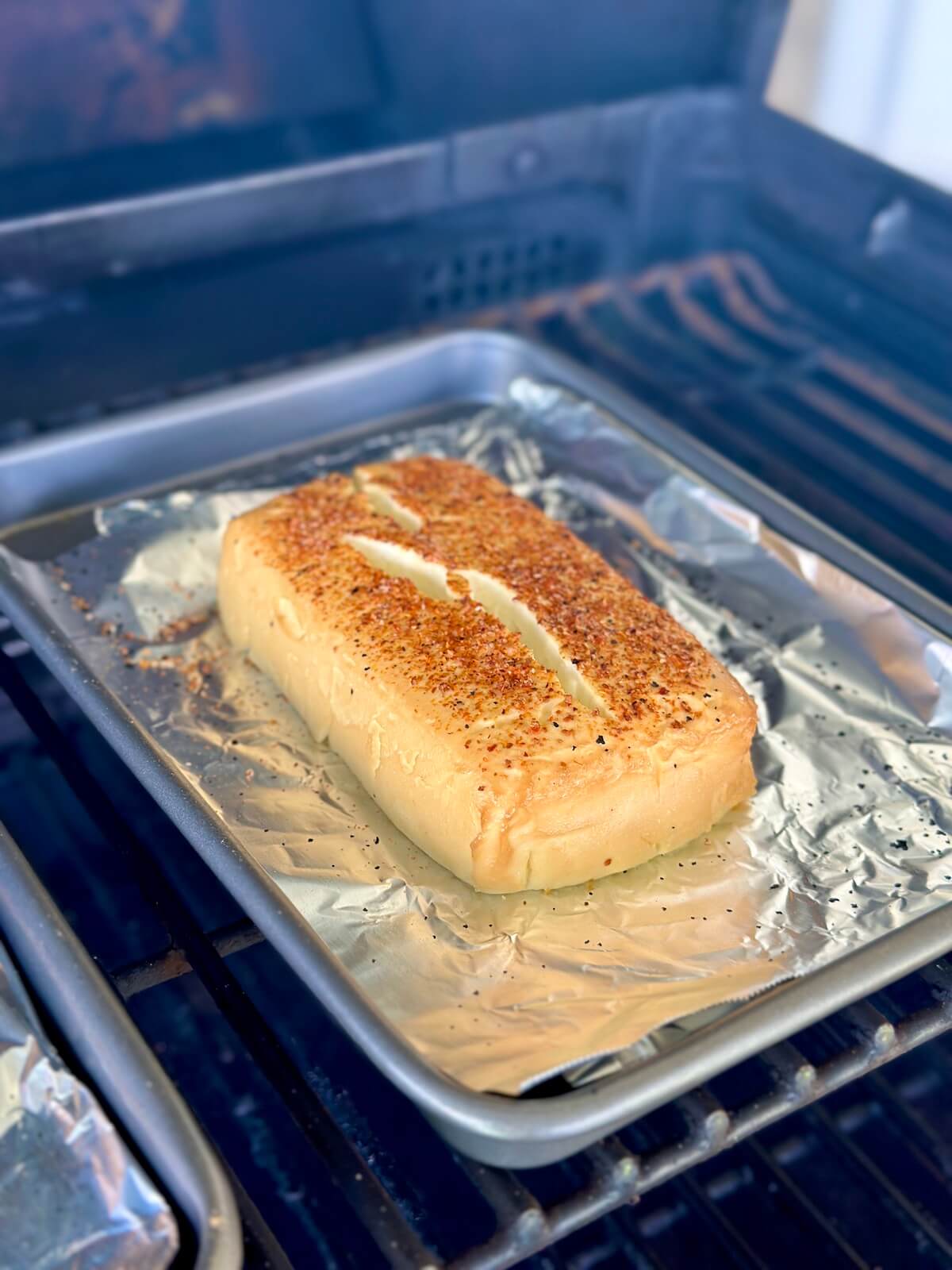 block of smoked cream cheese on a pellet grill