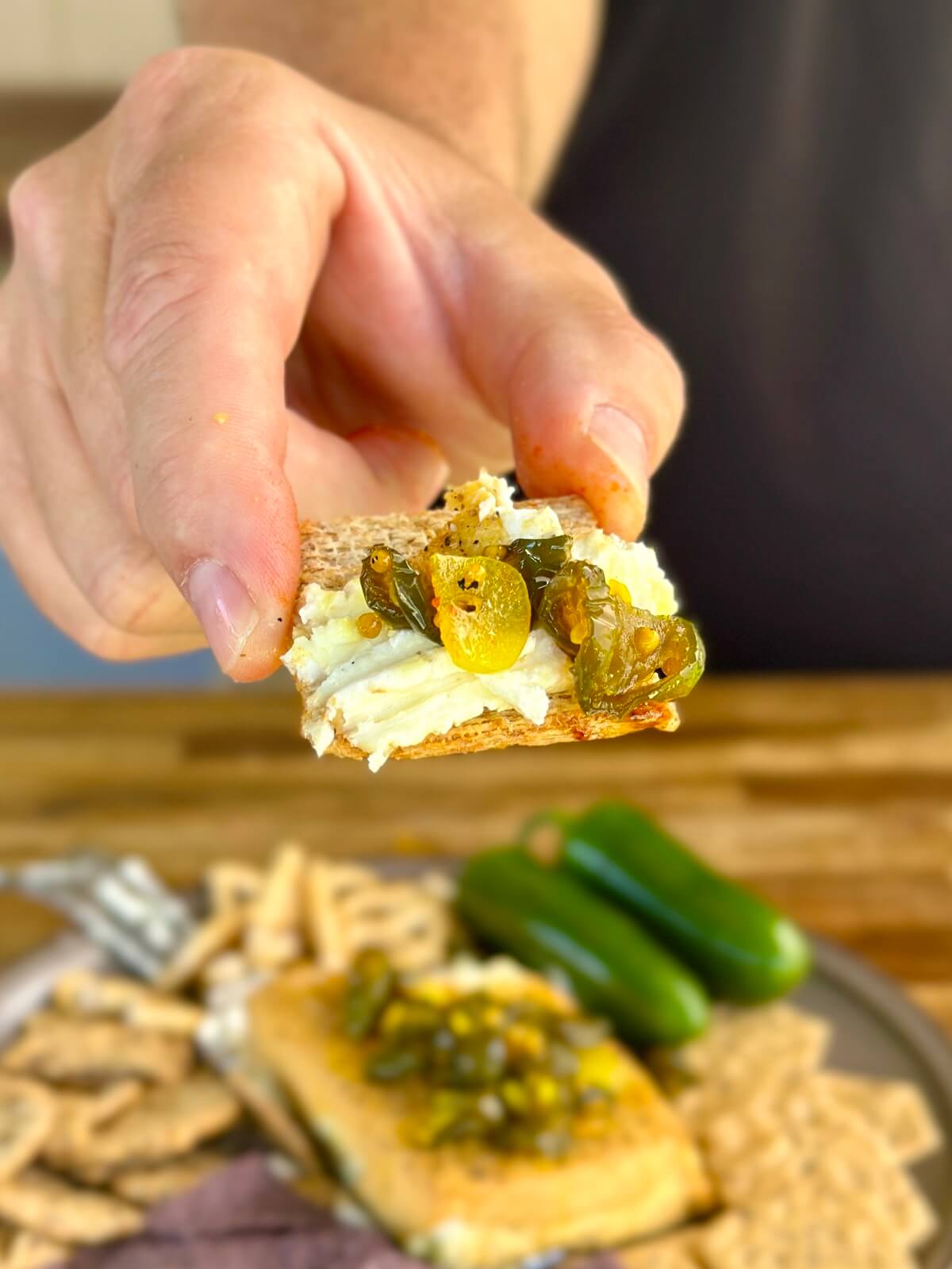 cracker with smoked cream cheese and candied jalapenos