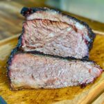 smoked brisket point sliced on a cutting board