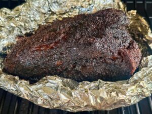 smoking a brisket point in an aluminum foil boat on a pellet grill