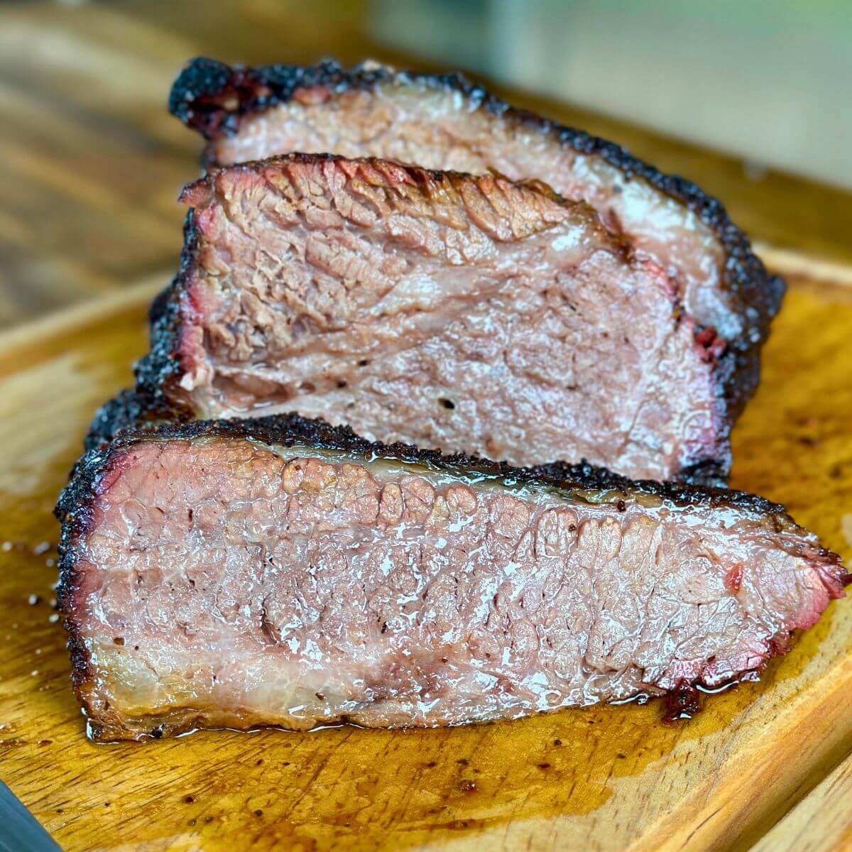 smoked brisket point sliced on a cutting board