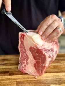 trimming large chunk of fat off a brisket point
