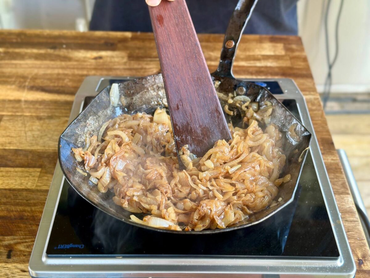 caramelizing thinly sliced onions in a skillet