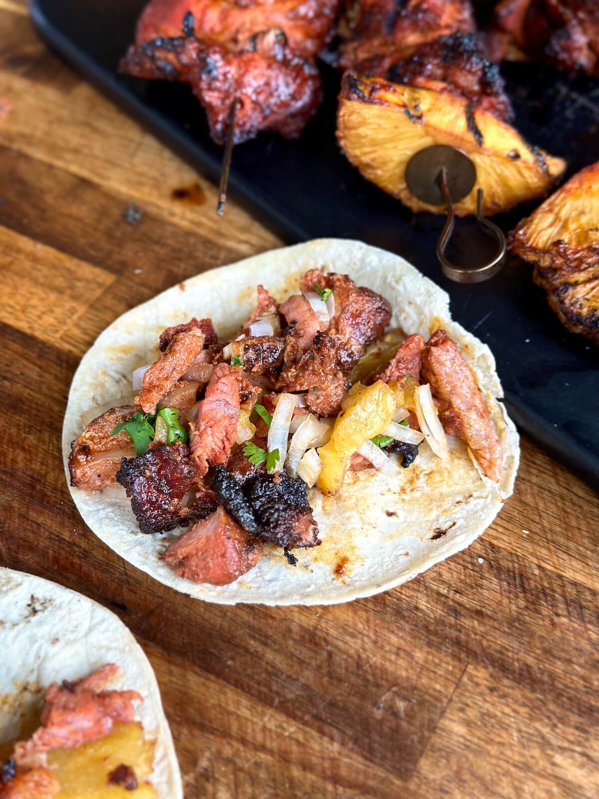 al pastor tacos with diced onion and pineapple