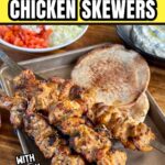 grilled Greek chicken skewers with pita, tzaziki, feta, and diced tomato