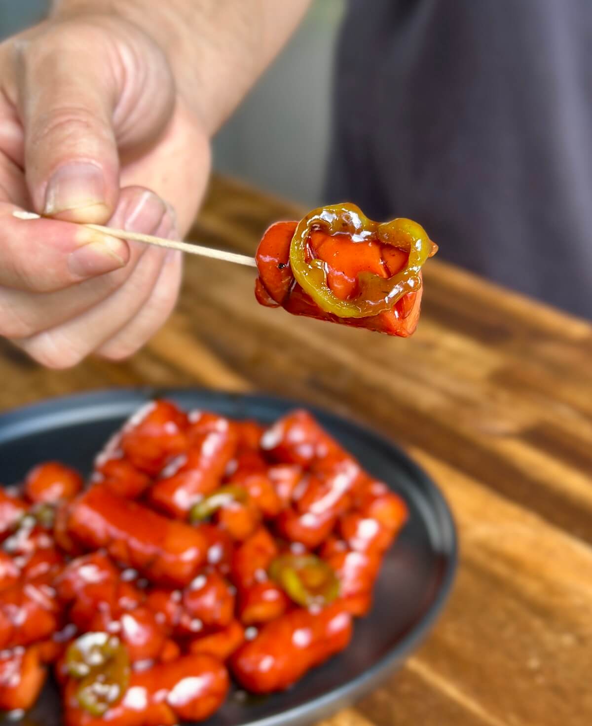 smoked hot dog burnt ends with barbecue sauce and pickled jalapenos