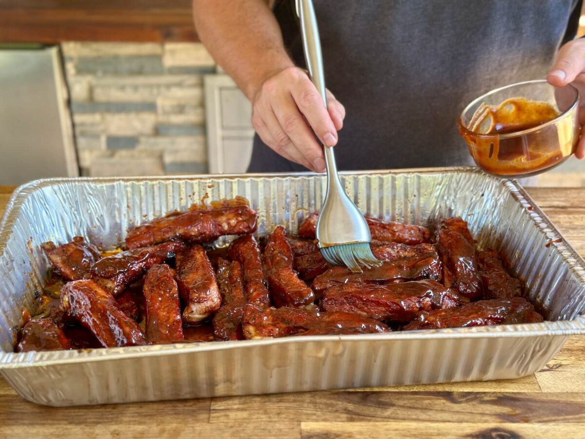 basting party ribs with barbecue sauce