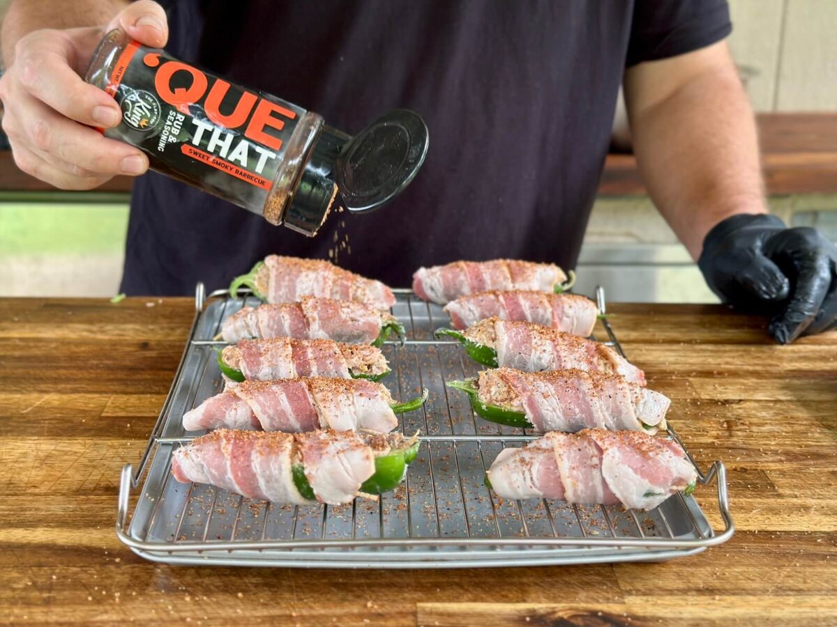seasoning bacon wrapped jalapeno poppers with Que That barbecue seasoning