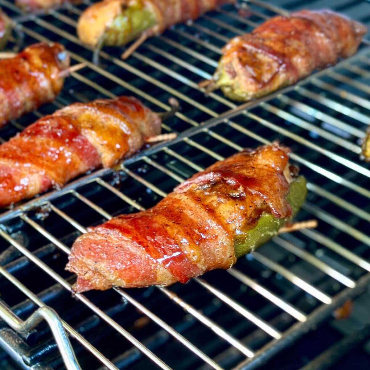 cooking pulled pork jalapeno poppers wrapped in bacon on a pellet grill