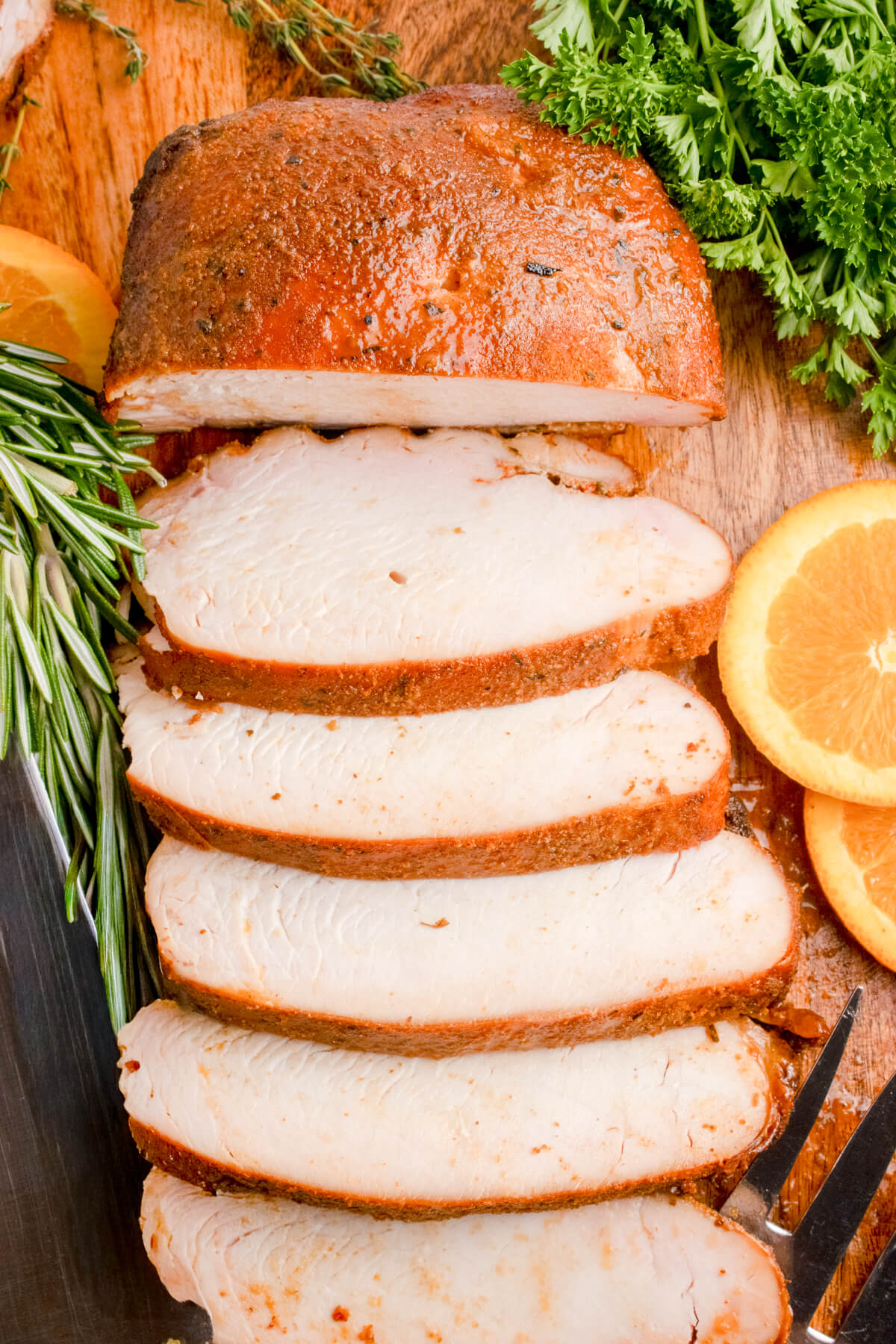 smoked turkey breast that has been sliced on a cutting board