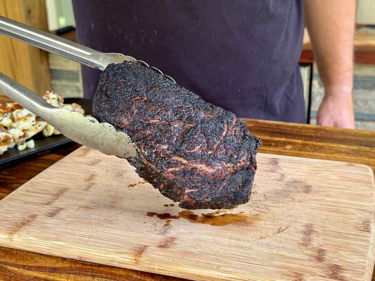 ribeye steak with a very dark almost black colored crust