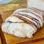 smoked pork loin sliced on a cutting board