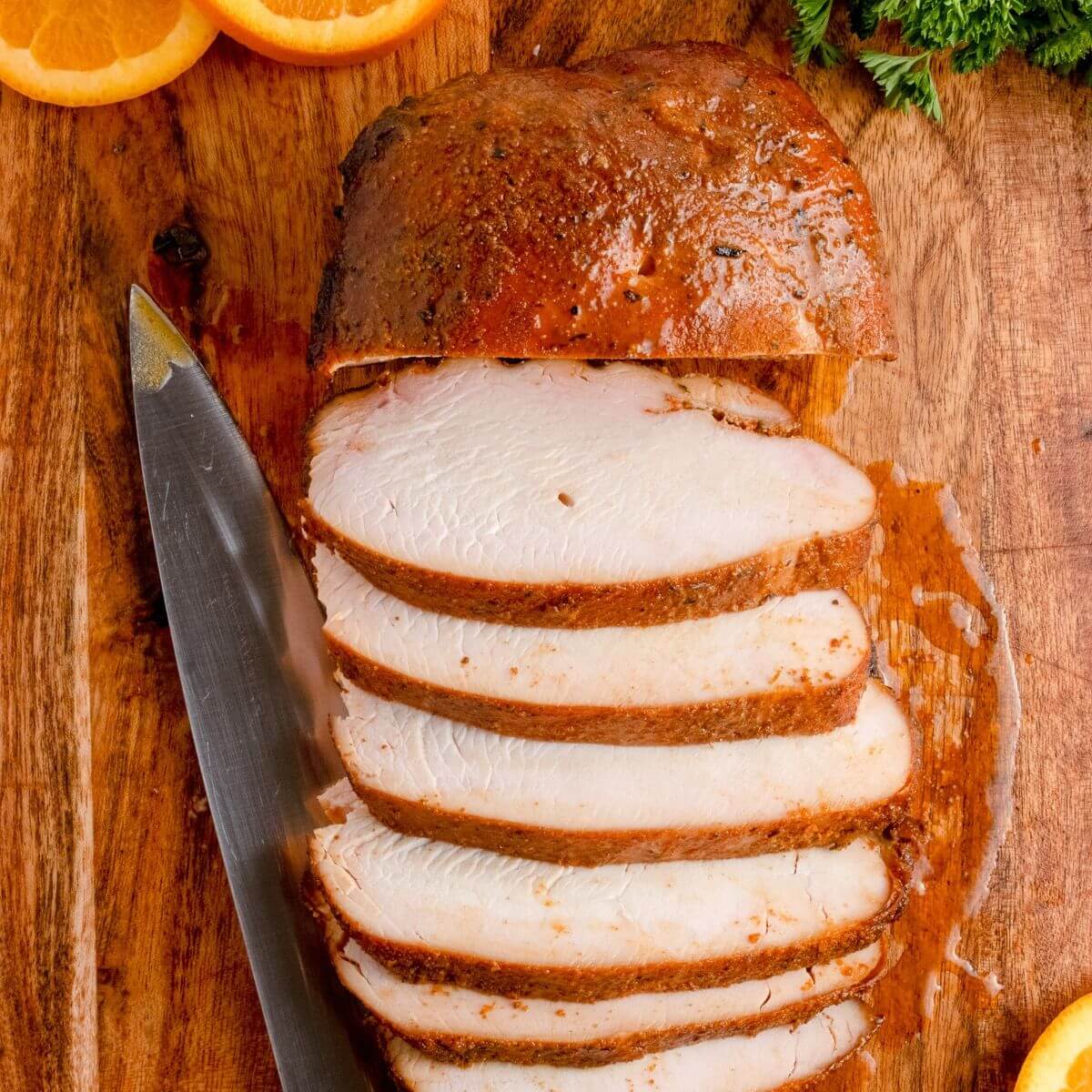 smoked turkey breast sliced on a cutting board