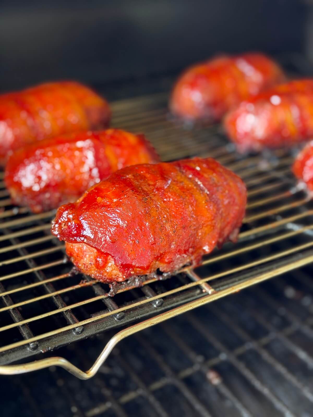 smoking barbecue glazed armadillo eggs on a pellet grill