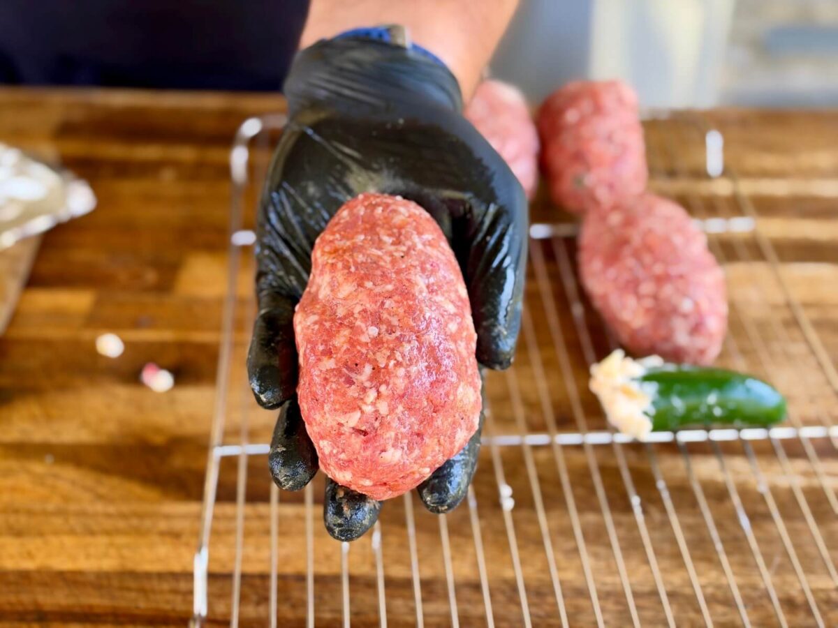 forming ground pork sausage into an egg shape